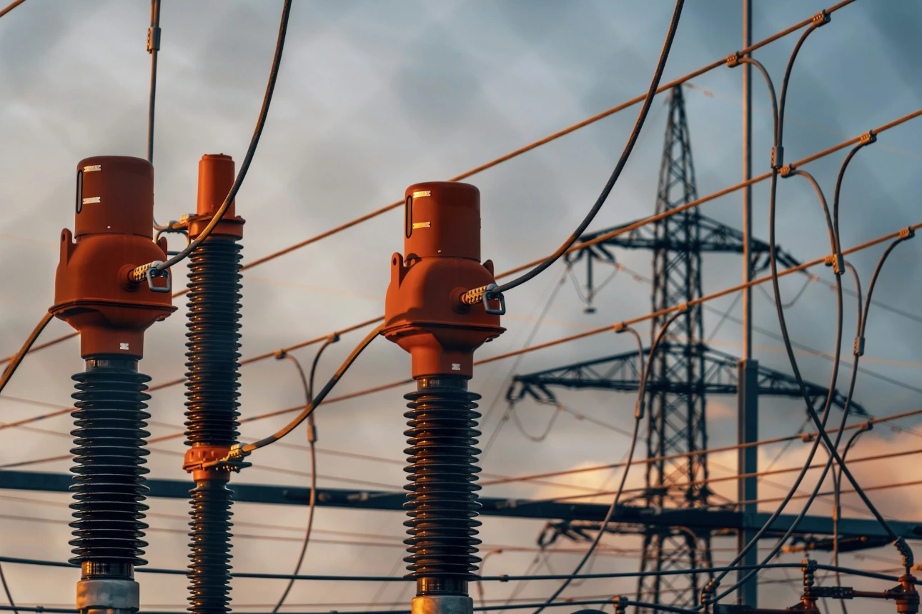 A row of power lines with a sky in the background